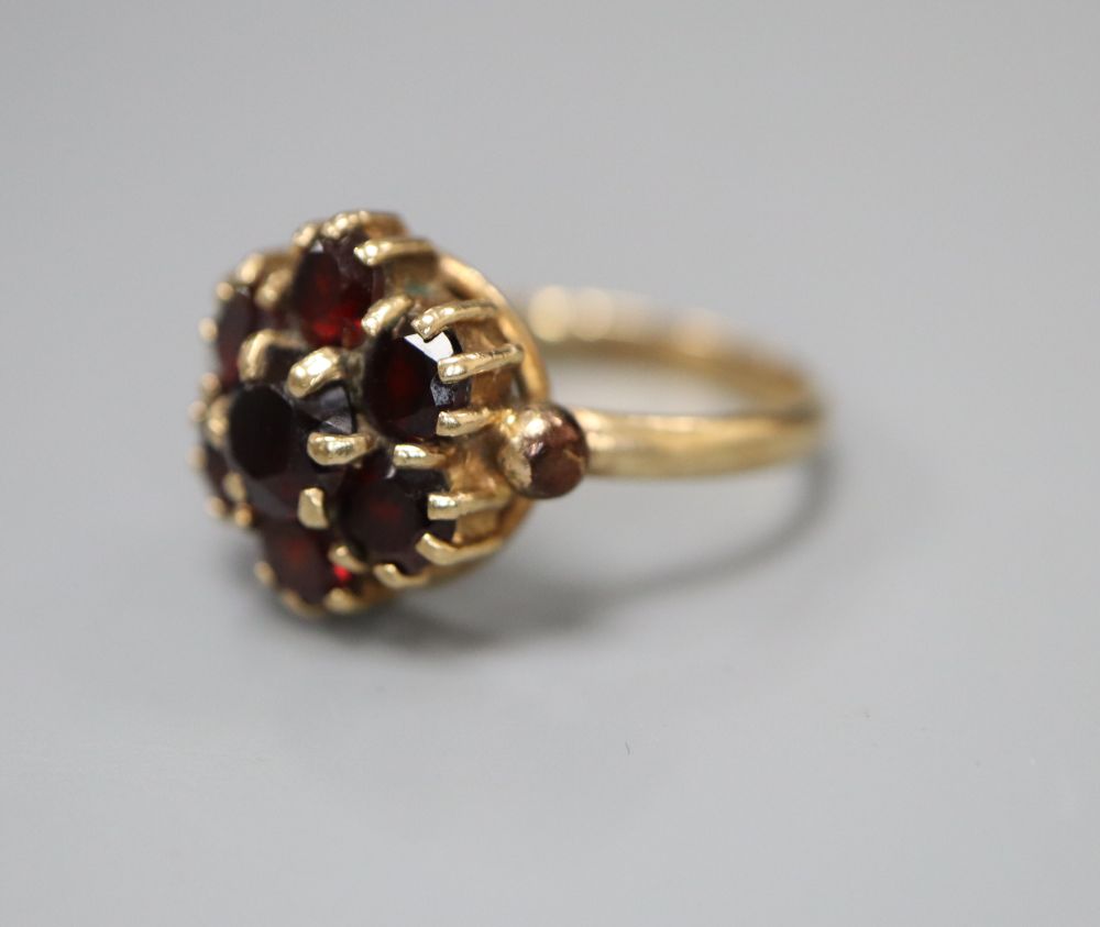 A 1960s 9ct gold and garnet cluster ring, size K/L, gross 3.2 grams.